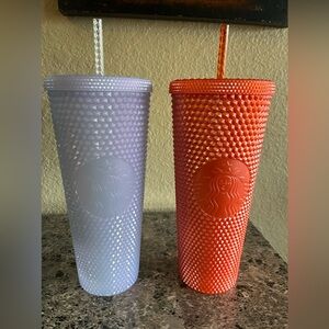 Two venti (24 fl oz) Starbucks tumblers.